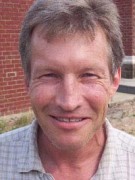 Smiling man with brown and gray hair